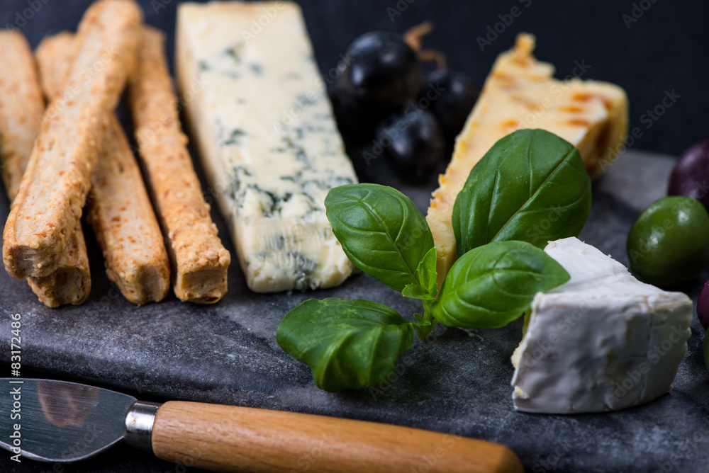 Tapas style cheese selection with olives,grapes and herbs Tapas style cheese selection with olives,grapes and herbs