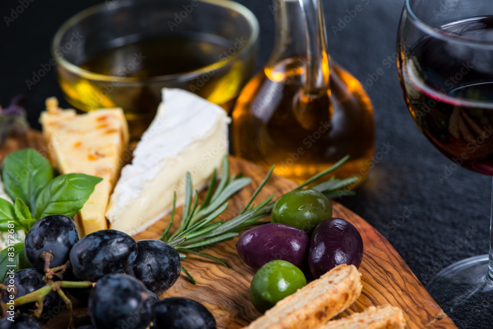 Tapas style board with cheese,olives and wine