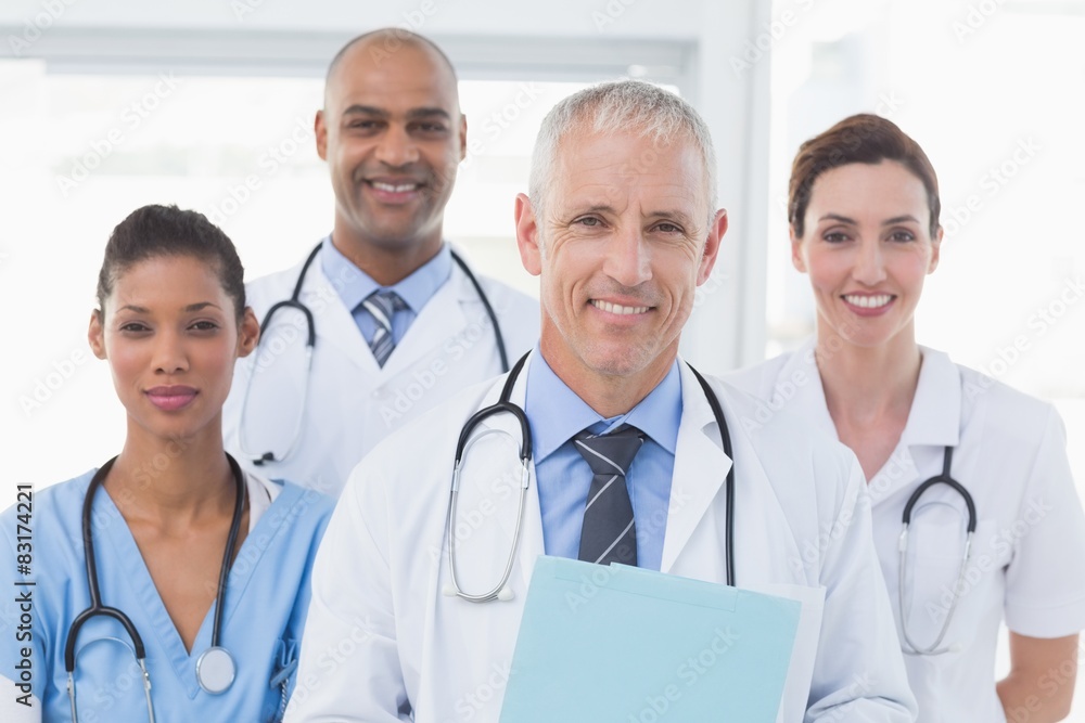 Team of smiling doctors looking at camera Team of smiling doctors looking at camera