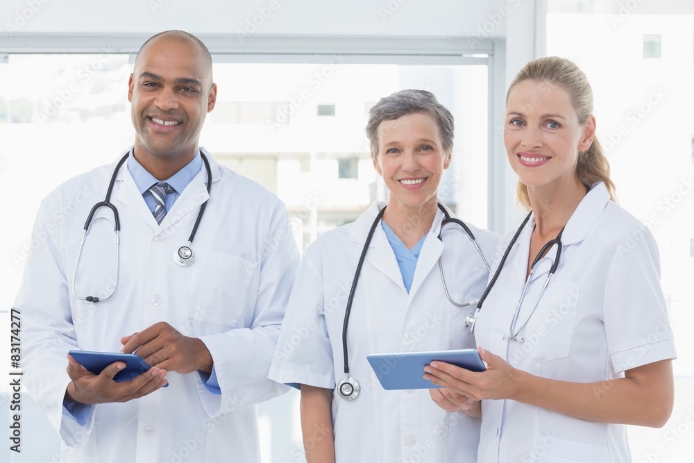 Team of smiling doctors working on their files Team of smiling doctors working on their files