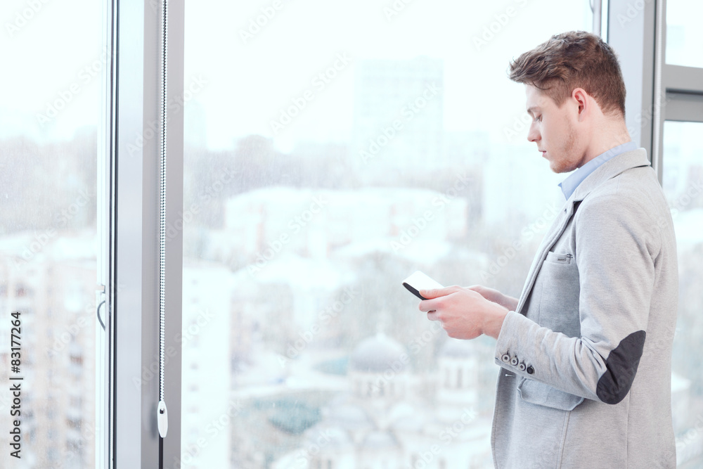 Fototapeta premium Young man standing with tablet