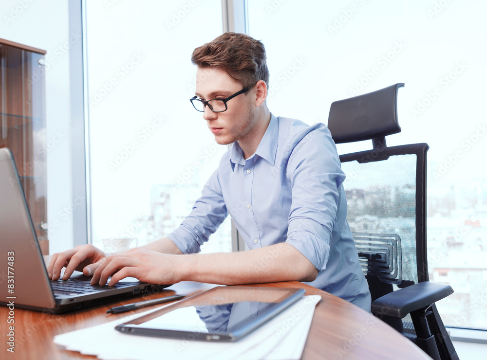 Businessman working on computer in office Businessman working on computer in office