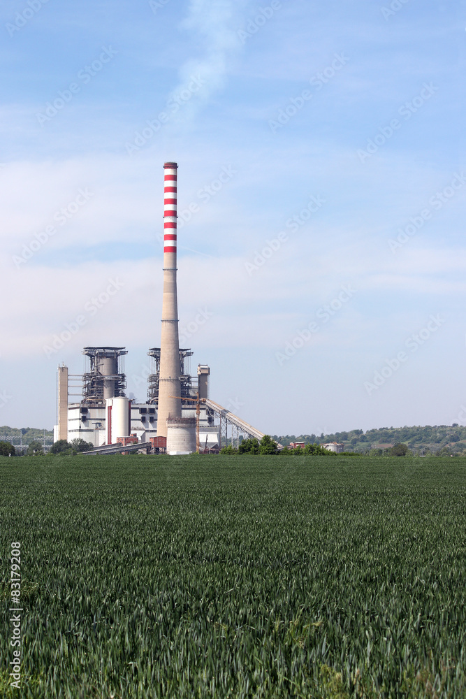 thermal power plant on green wheat field