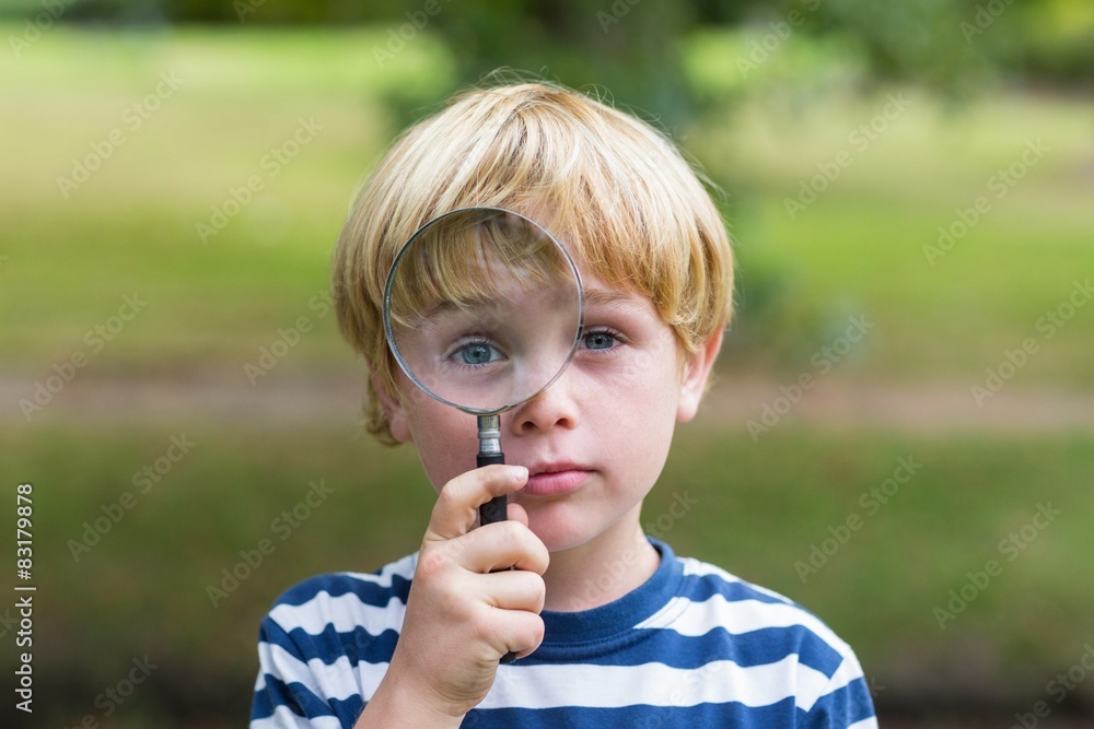 Curious little boy looking through magnifying glass Curious little boy looking through magnifying glass