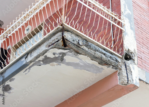 Fotografie, Obraz Balconies with cracked concrete requiring renovation
