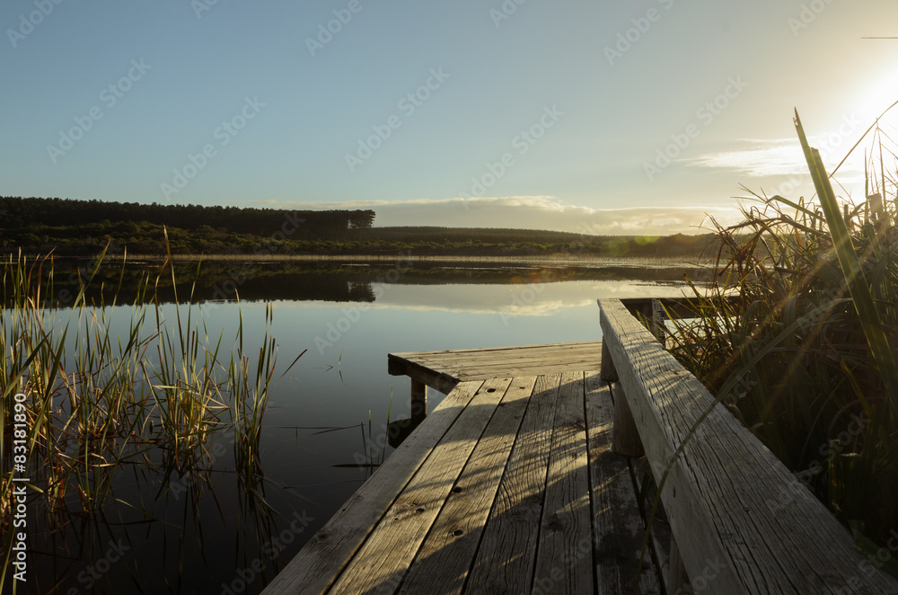 Wooden footpath at the lake in the morning