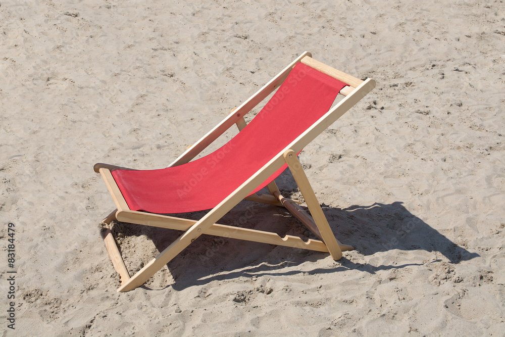 Red lounge chair in wood and fabrics in sand. Red lounge chair in wood and fabrics in sand.