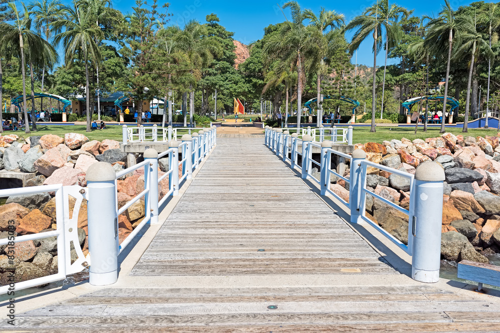 Tropical city public park with wooden bridge