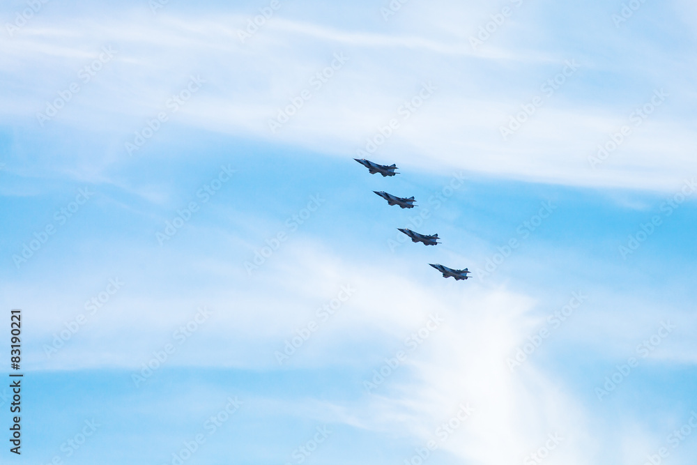 four military fighter aircrafts in cloudy sky
