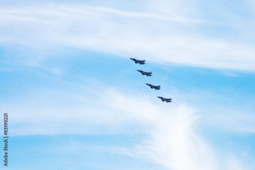 Obraz premium four military fighter aircrafts in cloudy sky