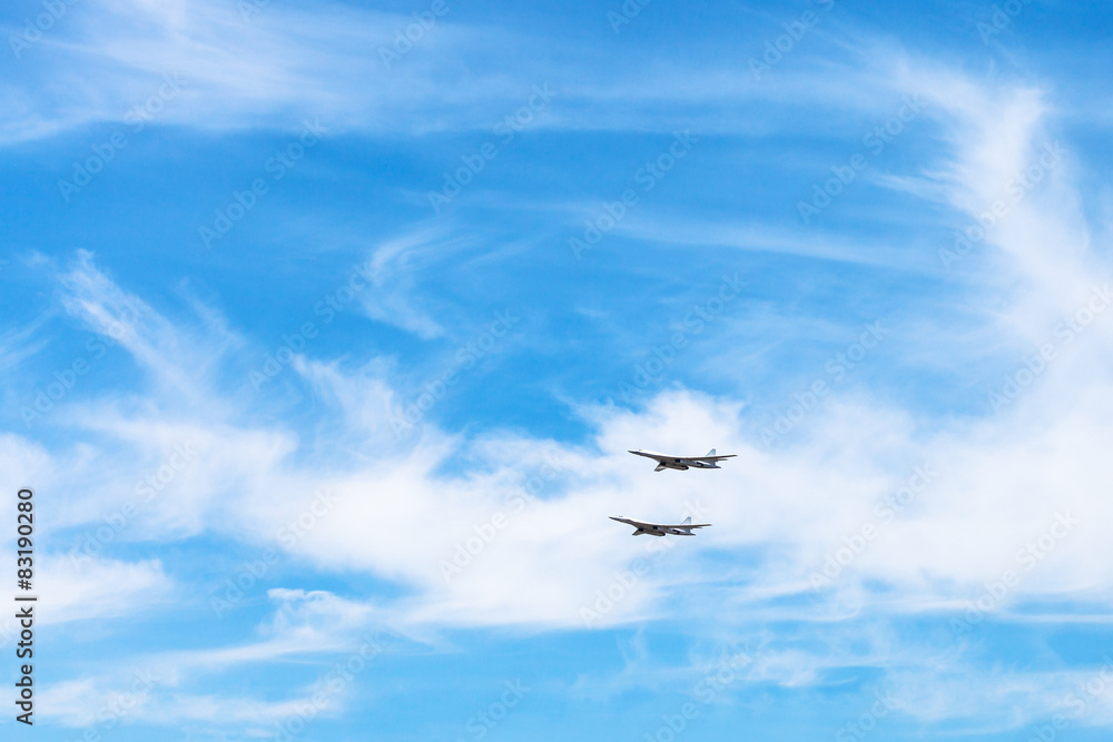 two strategic bomber aircrafts in white clouds
