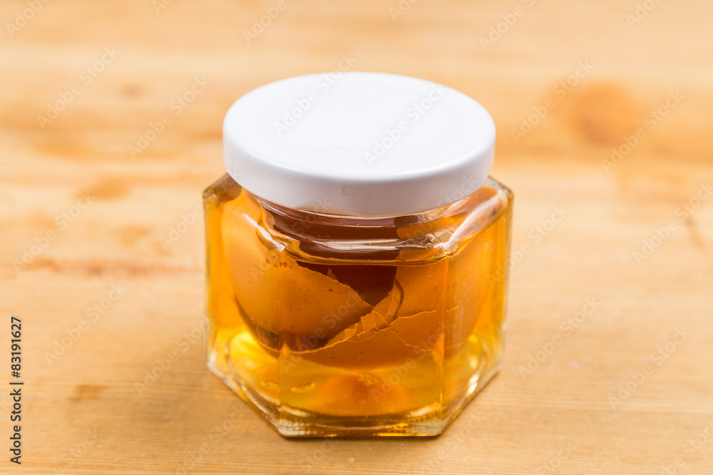 Jar containing apple cider vinegar soaked egg shells Jar containing apple cider vinegar soaked egg shells
