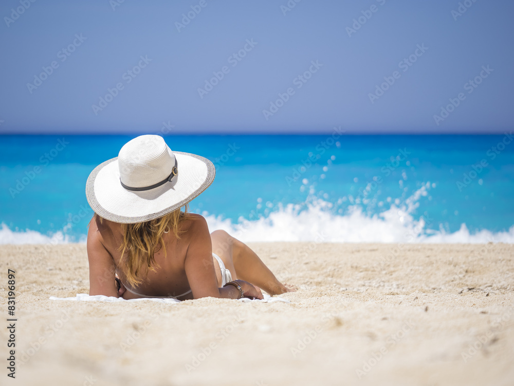 Woman relaxing on the famous Shipwreck beach in Zakynthos