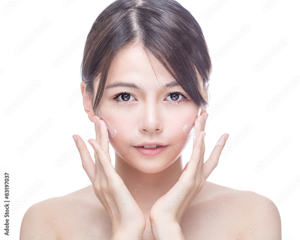 Asian beauty applying cream to face Asian beauty applying cream to face