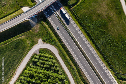 aerial view of highway and green harvest fields