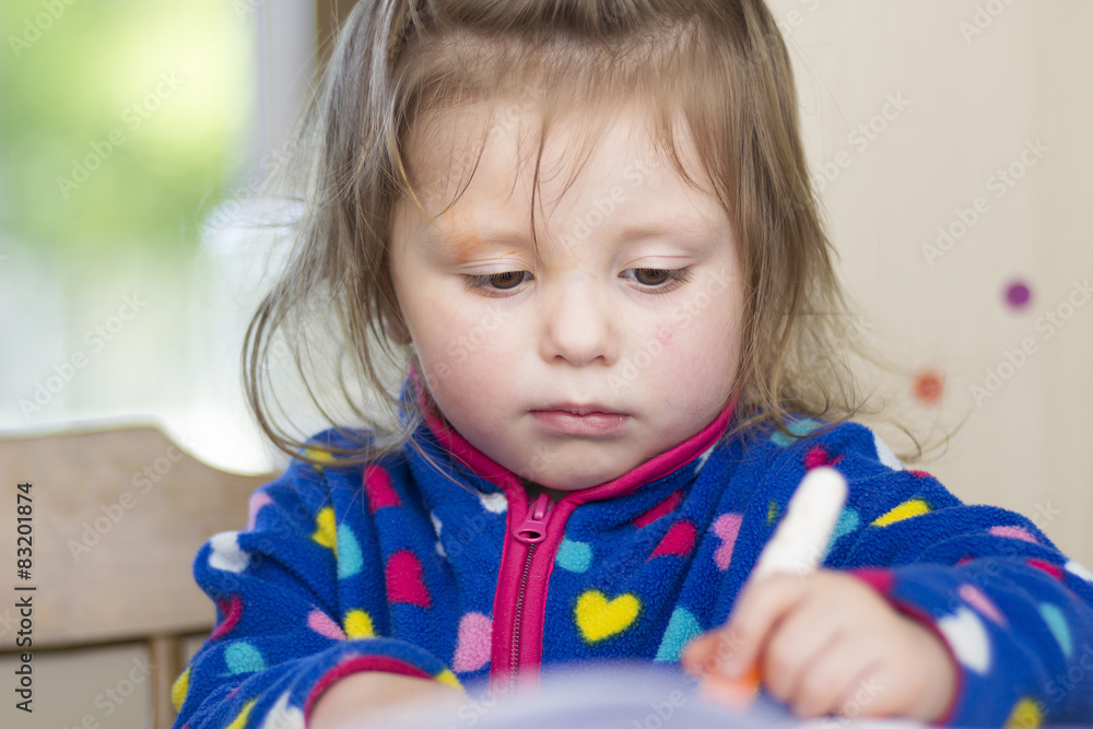 Little girl whose face is smudged with paint Little girl whose face is smudged with paint