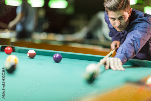 Young man playing pool