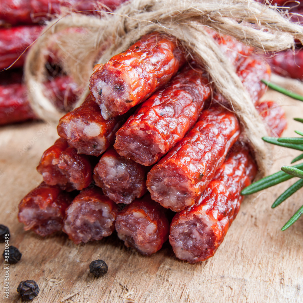 Snack stick sausage on rustic wood