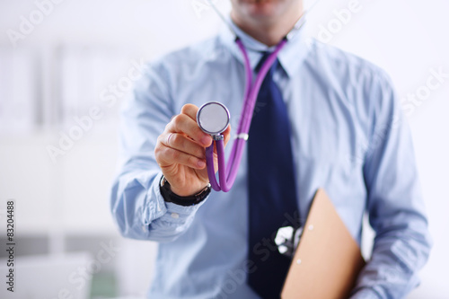 Male doctor with stethoscope listening something