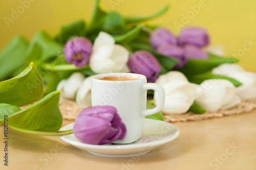 tulips on the table with cup of caffee