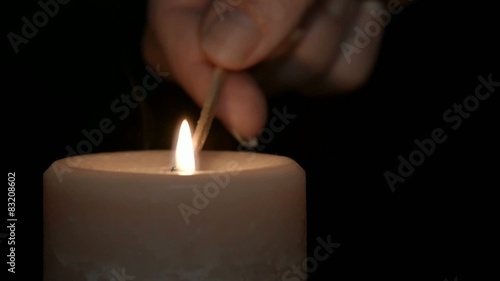 Match lighting a candle