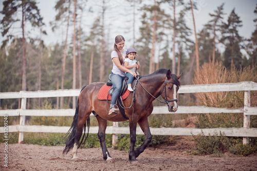 Mom and child horseback riding