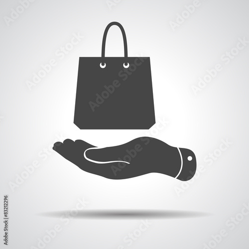 flat hand shows the shopping bag icon - vector illustration