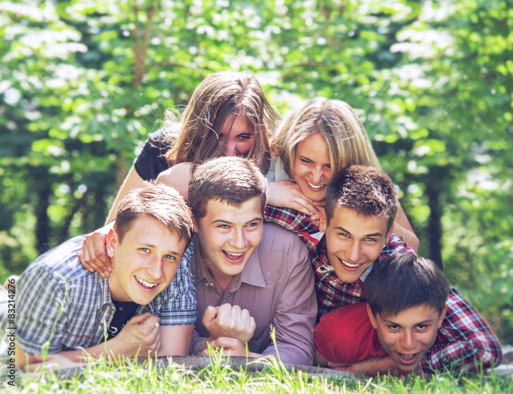 Happy teenagers friends have a fun in the summer park Happy teenagers friends have a fun in the summer park
