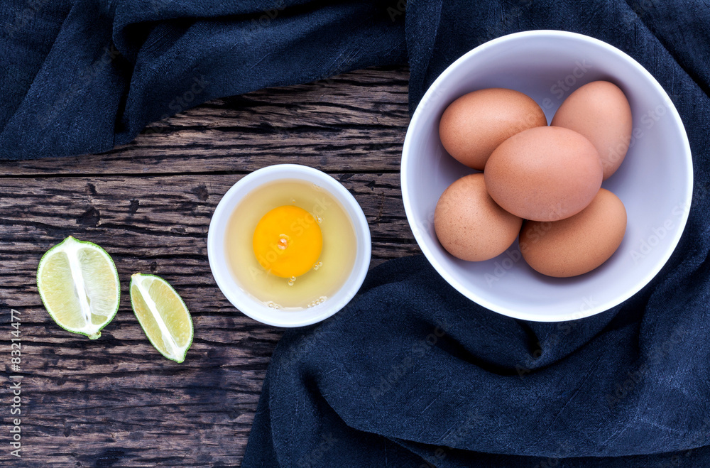 Fresh eggs in a bowl on the old wooden table . Fresh eggs in a bowl on the old wooden table .