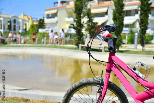 pink bicycle and group of girls outdoor games