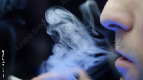 A man smokes a cigarette photo