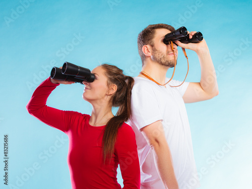 Couple looking through binoculars