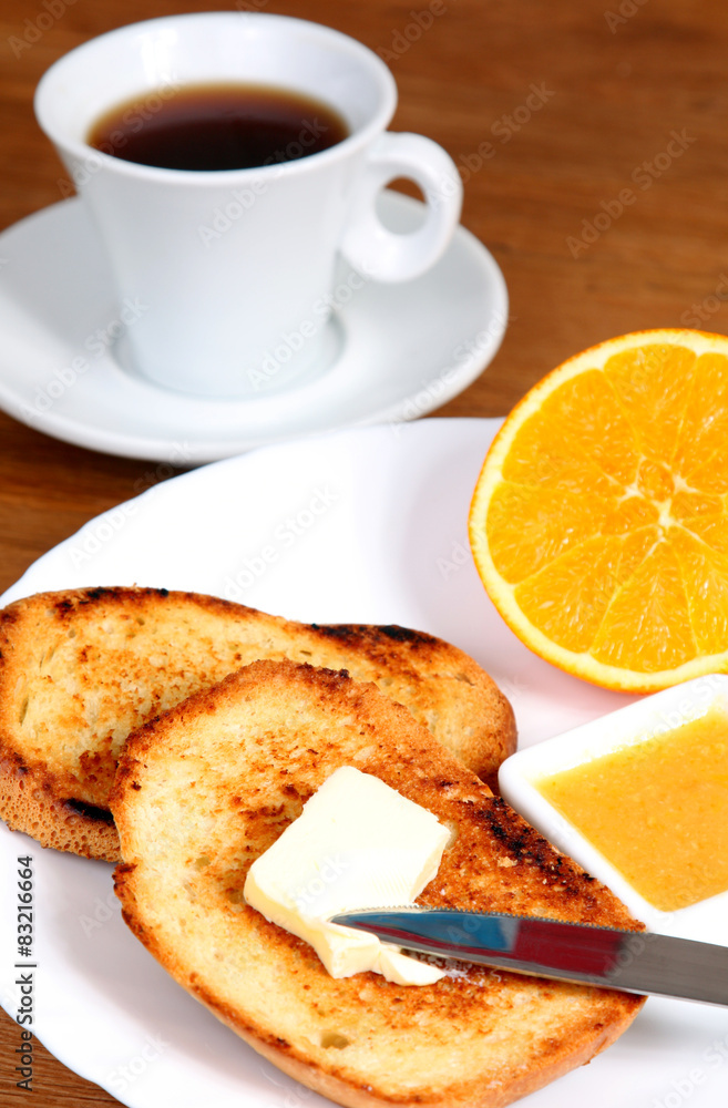 breakfast: cup of coffee, toasts, jam, butter and orange breakfast: cup of coffee, toasts, jam, butter and orange