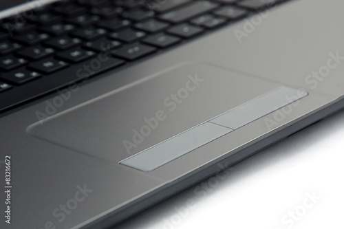 close-up touchpad and keyboard of the notebook on white