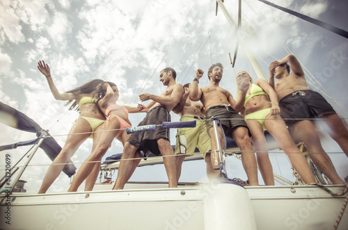 group of friends making party on the boat