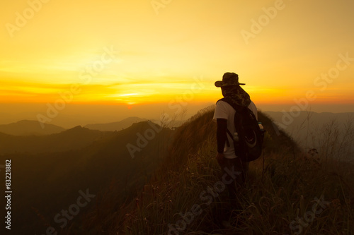 Hikers with backpacks relaxing on top of a mountain