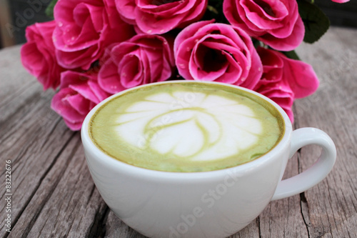 Green tea and milk for drinking with artificial roses