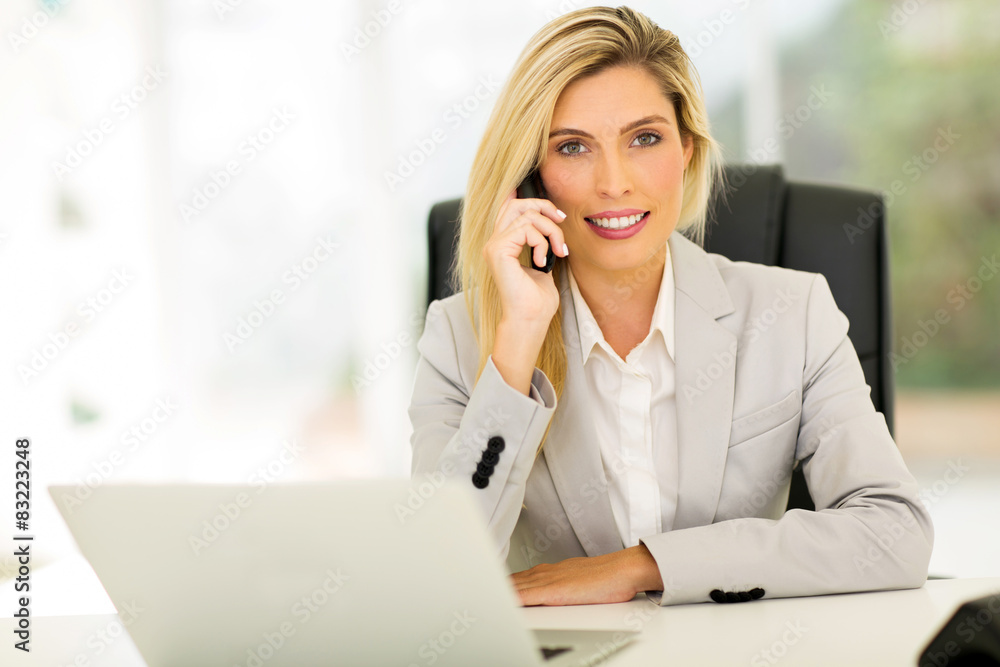young businesswoman talking on landline phone young businesswoman talking on landline phone