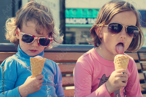 Two little girls eating ice cream.