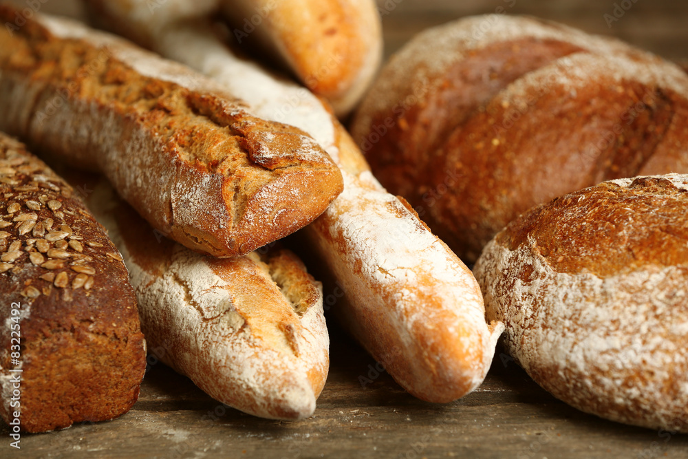 Different fresh bread on old wooden table