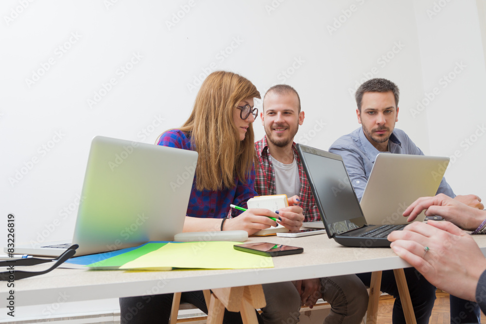 Young group of people discussing business plans. Young group of people discussing business plans.