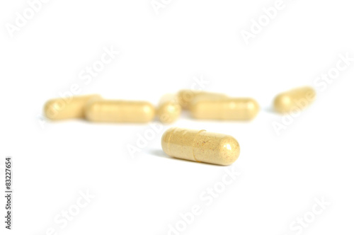 Herbal pill on white background