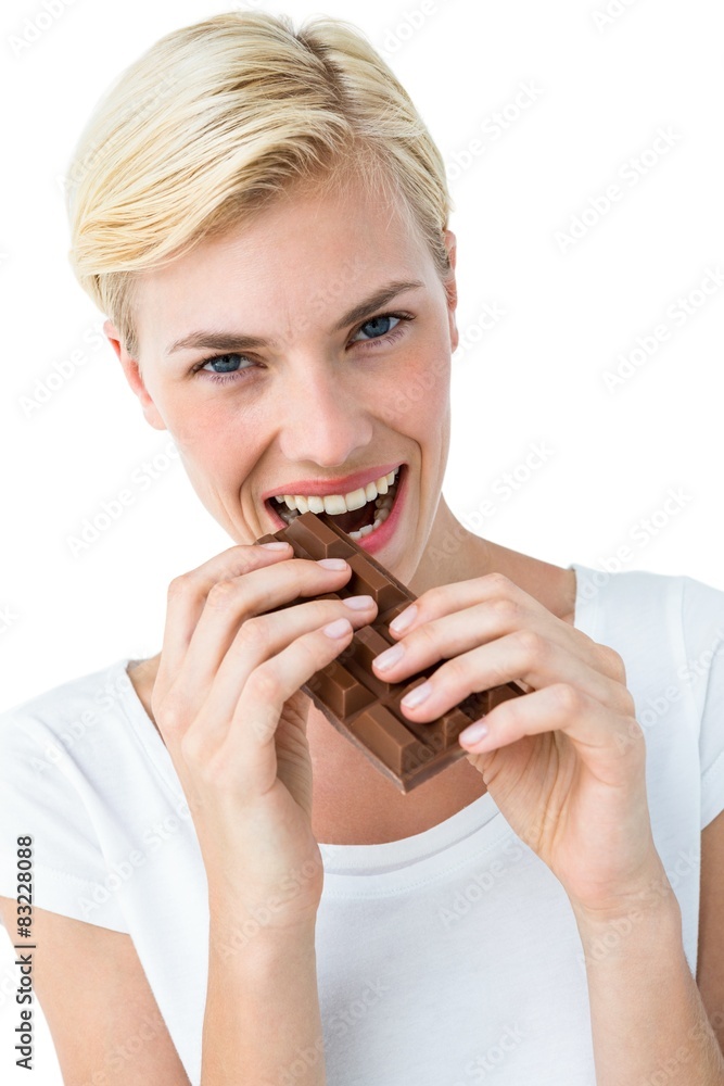 Attractive woman biting bar of chocolate Attractive woman biting bar of chocolate