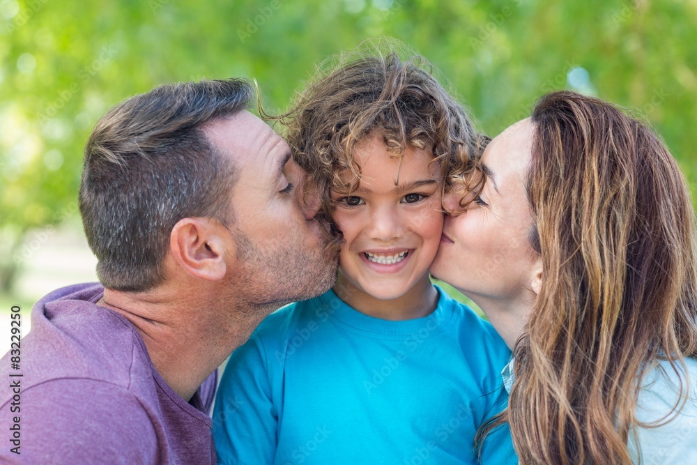 Happy family kissing at camera in the park Happy family kissing at camera in the park