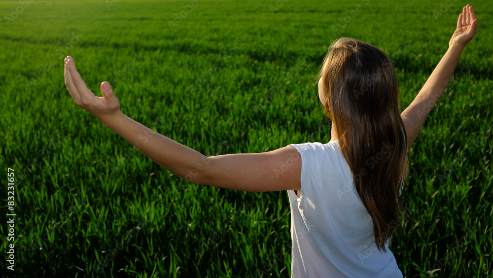 Young girl spreading her arms in a freedom gesture Young girl spreading her arms in a freedom gesture