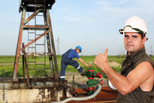 oil worker with thumb up on oilfield