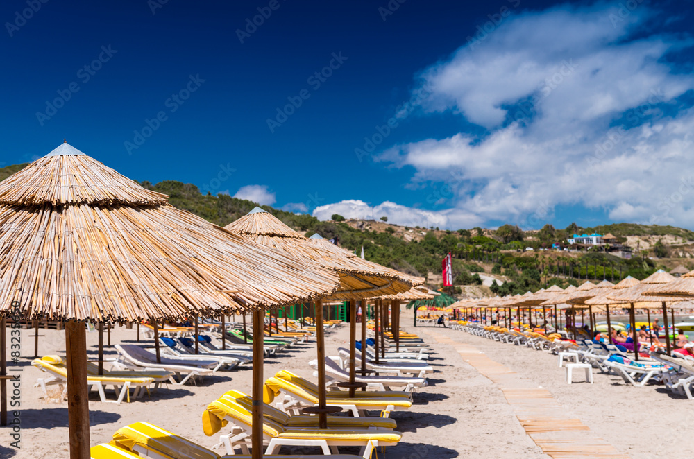 Rows of straw umbrellas on a beautiful beach