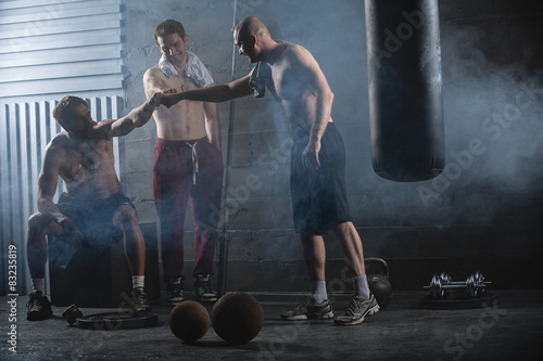 Rest three guys who have completed a complex crossfit workout