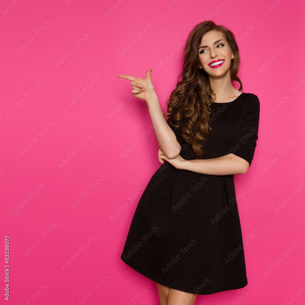 Fashion Model In Black Dress Pointing - obrazy, fototapety, plakaty 