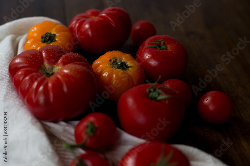 mix of fresh organic red yellow cherry tomatoes rustic dark wood